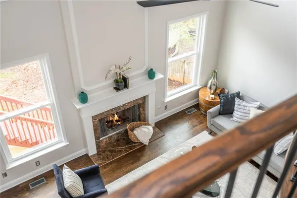 a bedroom with a bed and a dresser with wooden floor