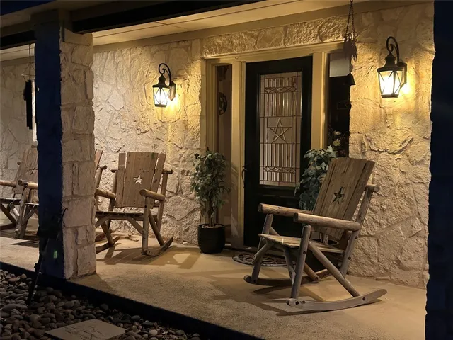 a outdoor dining space with furniture and chandelier