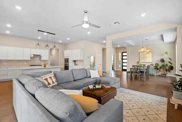 a living room with furniture and kitchen view