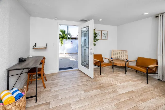 a living room with furniture and a dining table with chairs