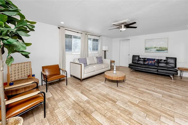 a living room with furniture a rug and a window