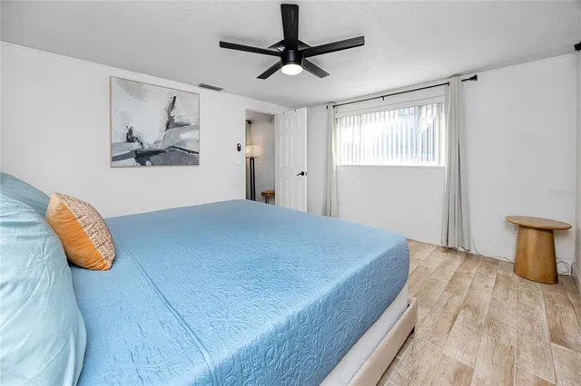 a bedroom with a bed and a chandelier