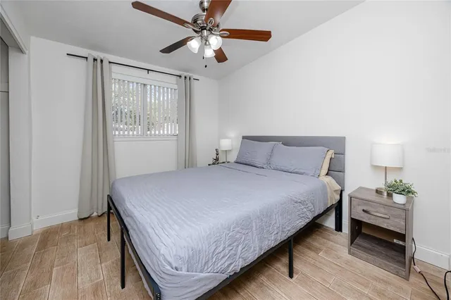 a bedroom with a bed chandelier and a window