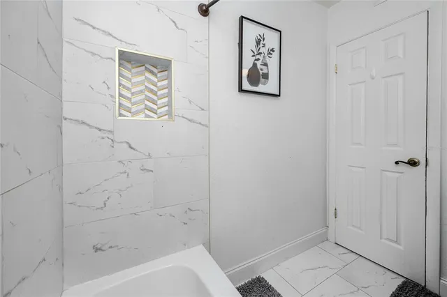 a bathroom with bathtub and shower