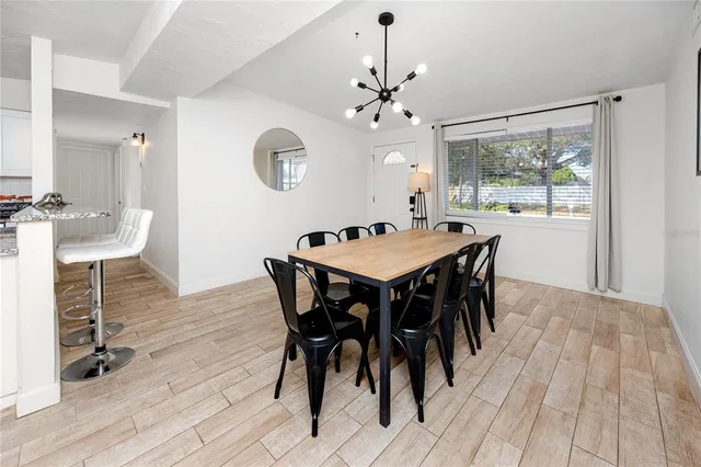 a view of a dining room with a table and chairs