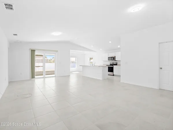 an empty room with windows and closet