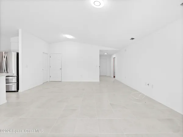 a view of a kitchen with a sink and dishwasher a stove top oven with white cabinets