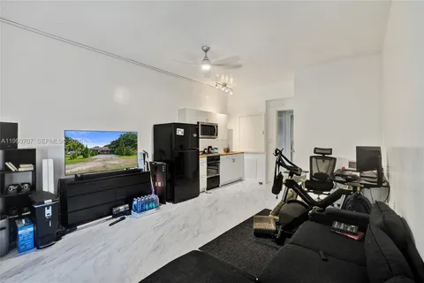 a room with furniture a flat screen tv and a floor to ceiling window
