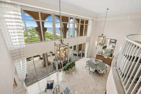 a living room with furniture and a floor to ceiling window
