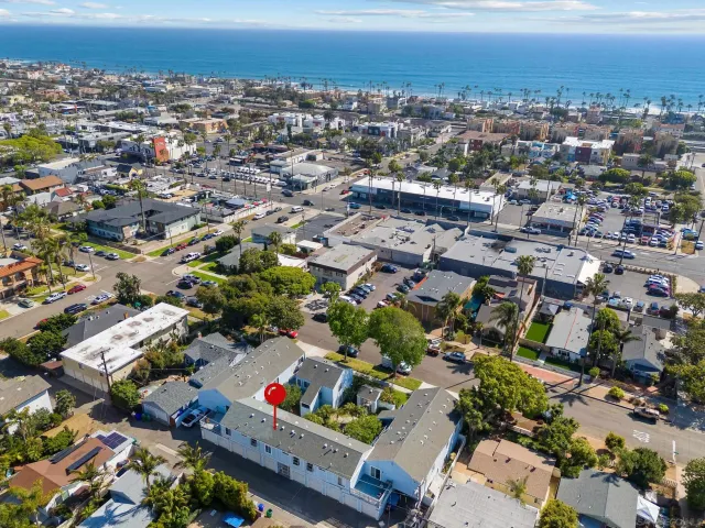 an aerial view of residential houses with city view