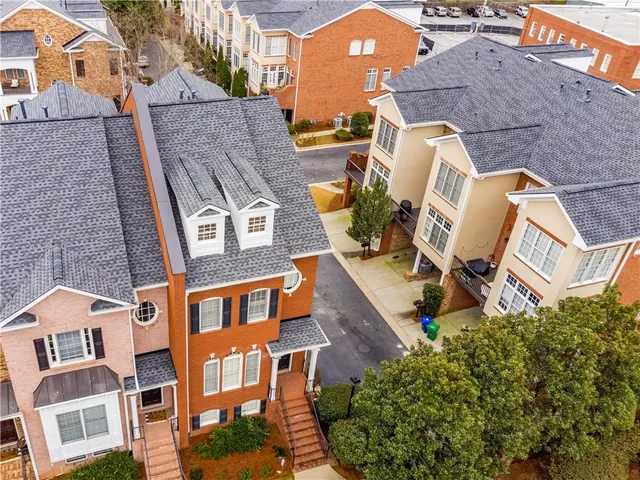 an aerial view of a residential apartment building with a yard