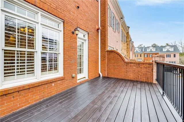 a view of a balcony with wooden floor and fence