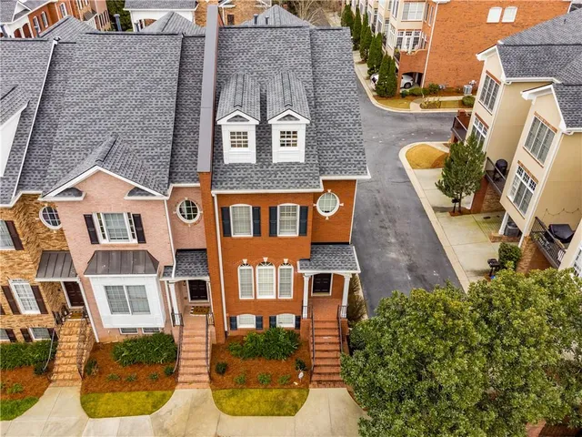 front view of a brick house with a yard
