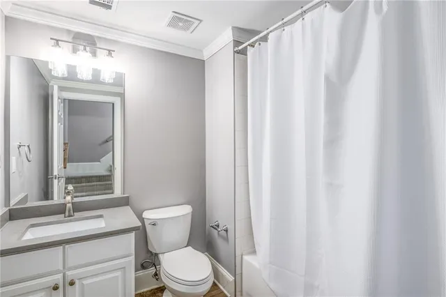 a bathroom with a granite countertop toilet a sink and a mirror