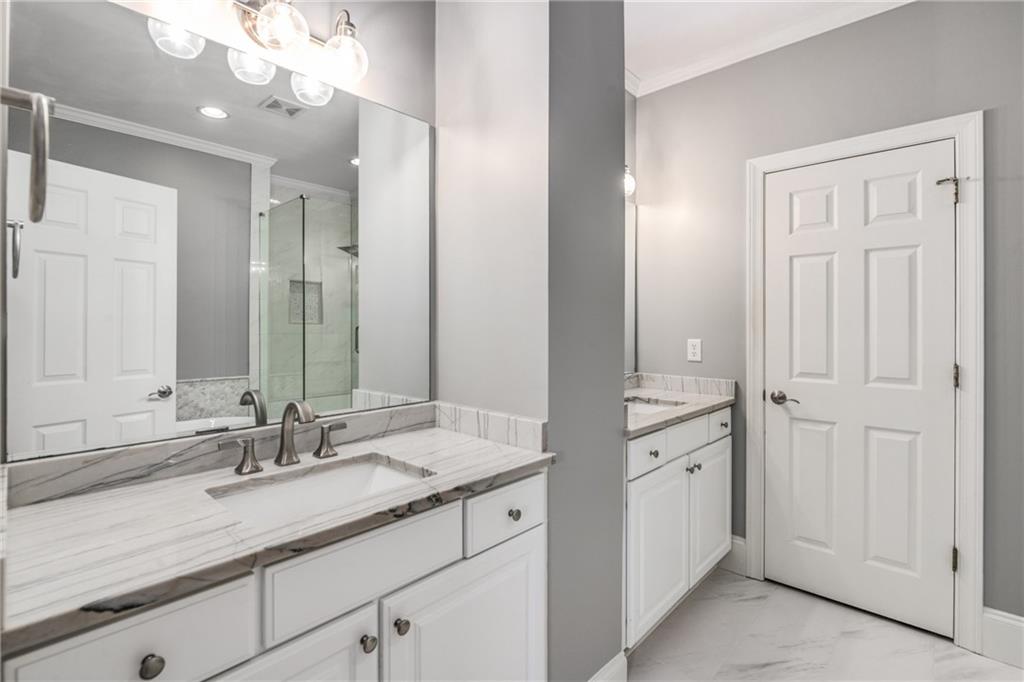 2586 Brookhaven Chase Lane Northeast Atlanta, GA 30319 - Photo 30 of 51 a bathroom with a sink vanity granite and a mirror