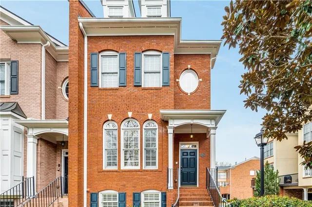 a view of a brick building with large windows
