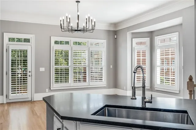 a kitchen with granite countertop a stove and cabinets