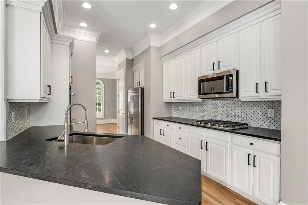 2586 Brookhaven Chase Lane Northeast Atlanta, GA 30319 - Photo 43 of 51 a kitchen with stainless steel appliances granite countertop a sink a stove and a microwave