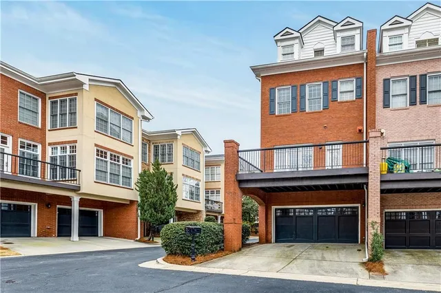 a front view of a house with a garage and balcony