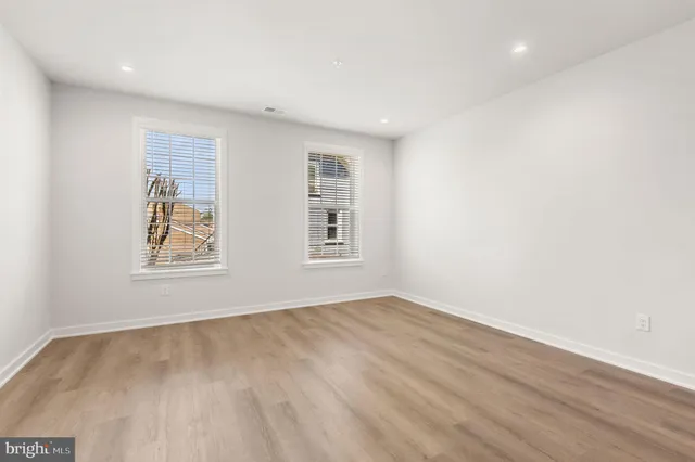 a kitchen with stainless steel appliances a refrigerator and a stove top oven