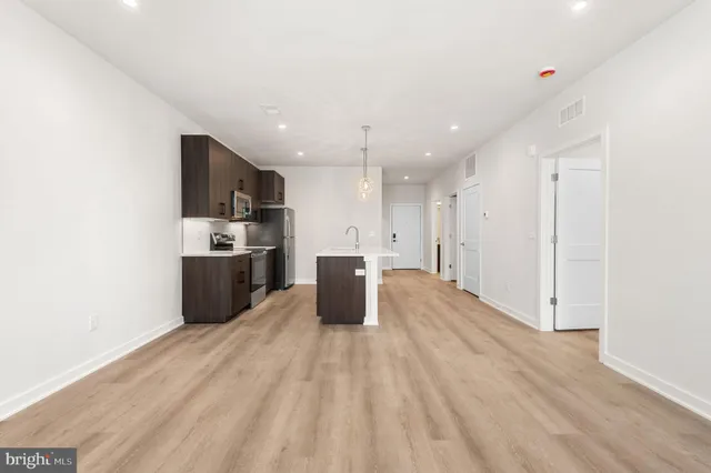 a view of kitchen with refrigerator and window