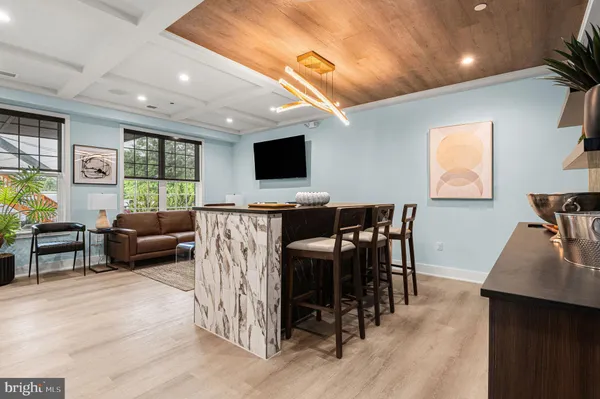 a kitchen with stainless steel appliances a table and chairs