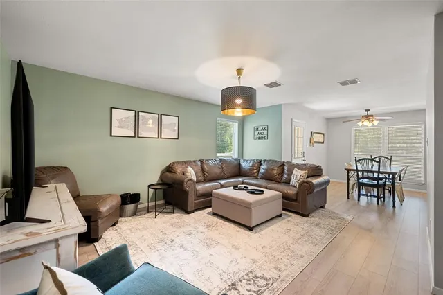 a living room with furniture a rug and a chandelier