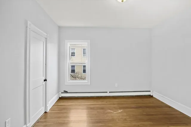 a view of a room with wooden floor and white walls