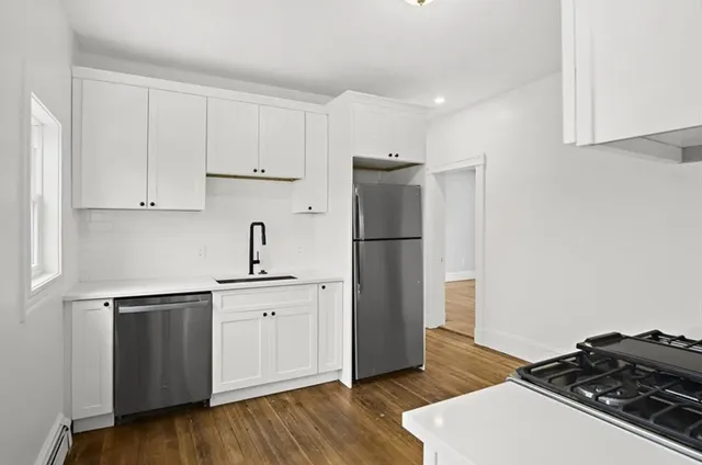a kitchen with a sink and a refrigerator