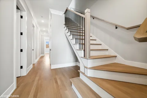 a view of entryway and hall with wooden floor
