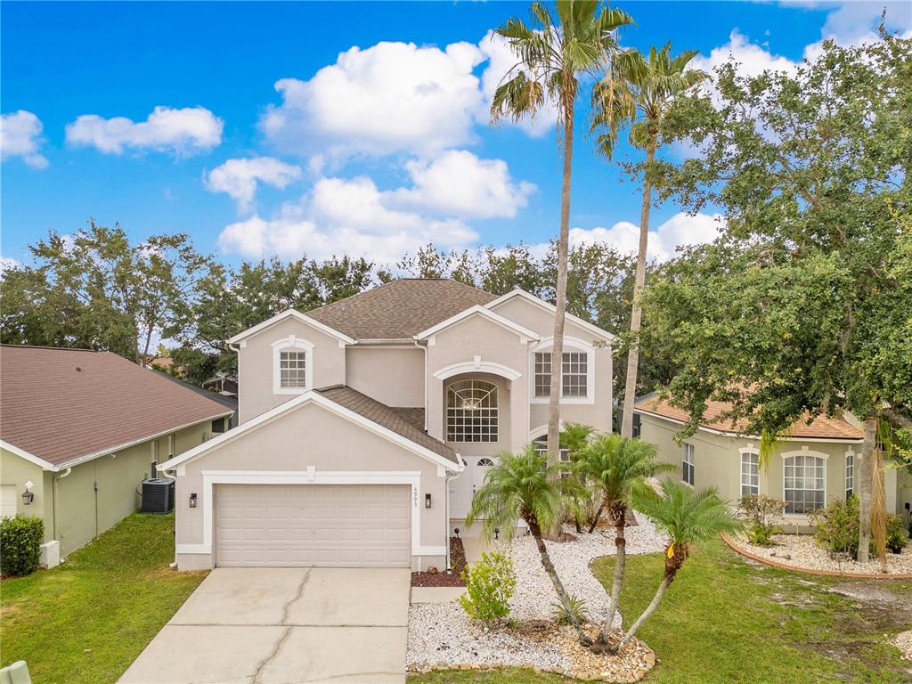 4993 Hook Hollow Circle Orlando, FL 32837 - Photo 1 of 1 a front view of a house with a garden and trees