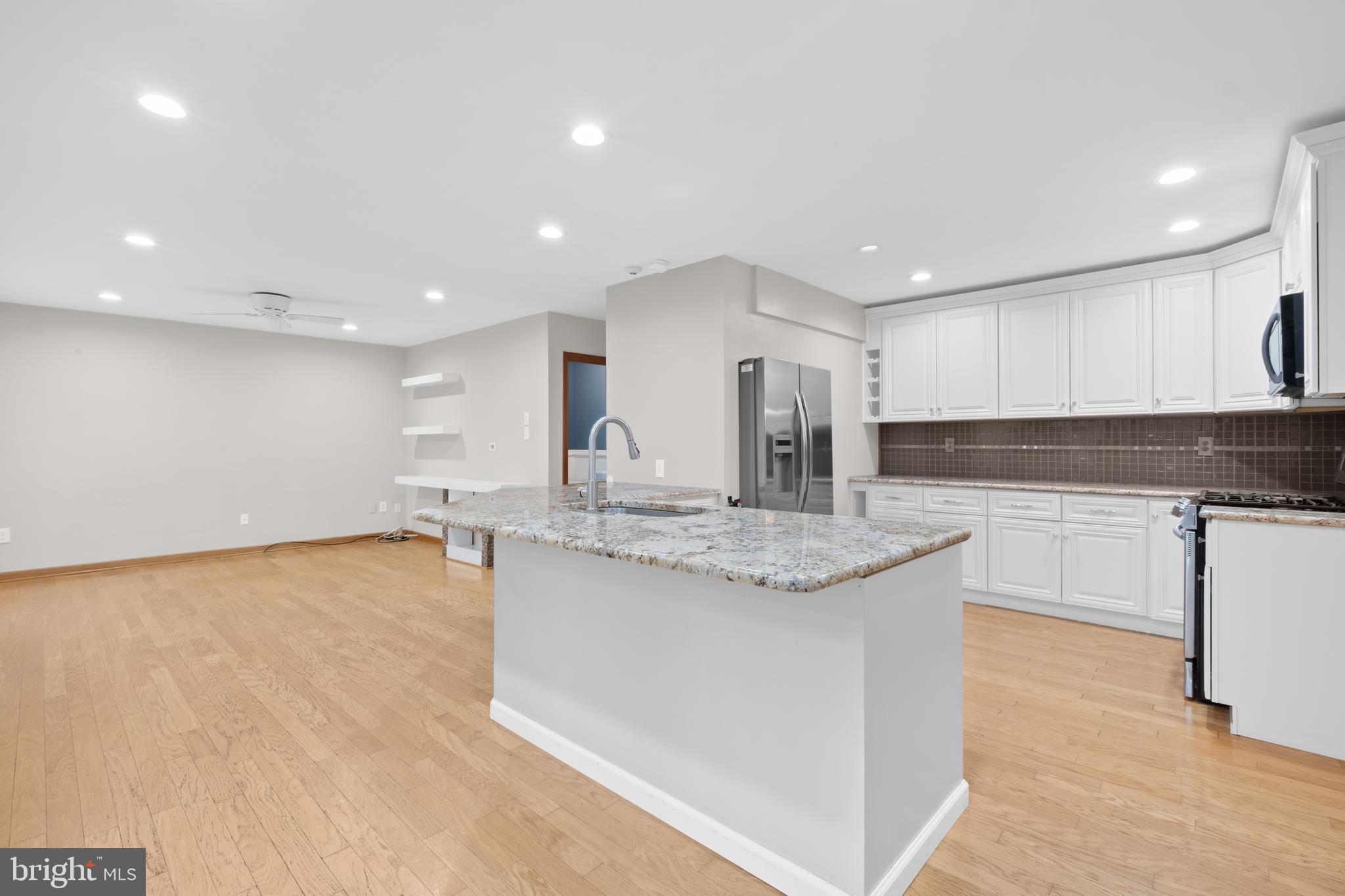 127 Heath Road Medford, NJ 08055 - Photo 13 of 63 a large kitchen with granite countertop a sink and a white cabinets