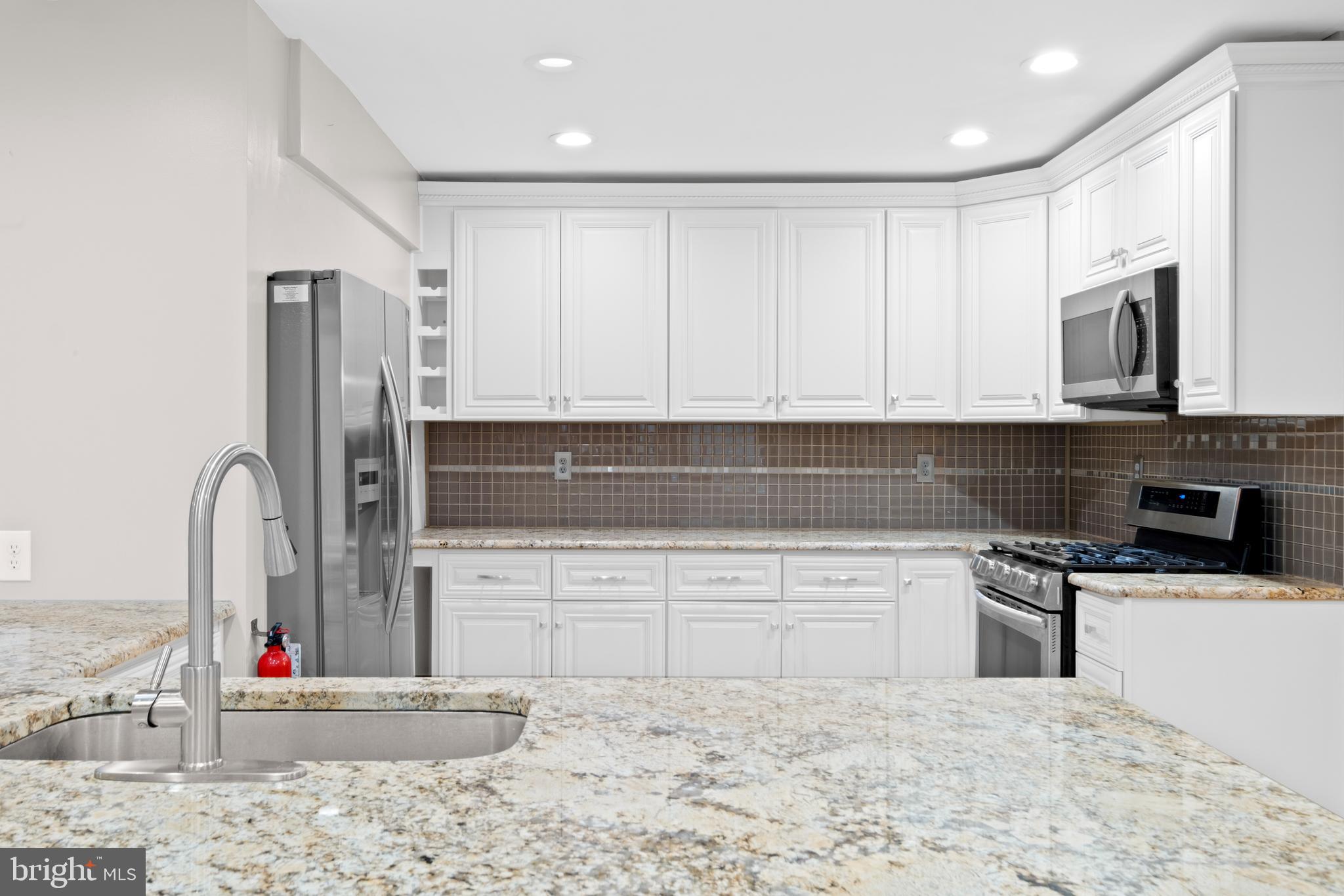 127 Heath Road Medford, NJ 08055 - Photo 15 of 63 a kitchen with stainless steel appliances cabinets a sink and a microwave
