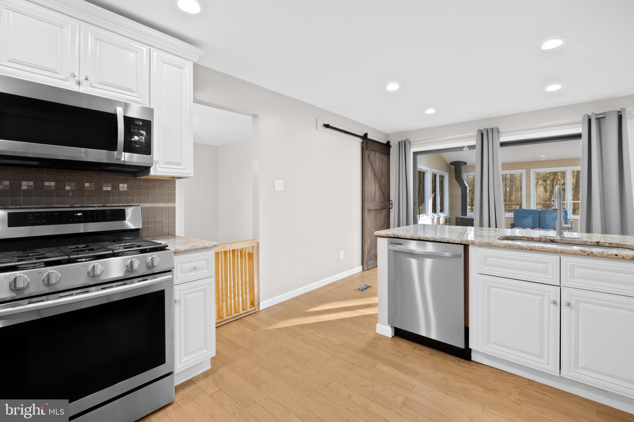 127 Heath Road Medford, NJ 08055 - Photo 16 of 63 a kitchen with stainless steel appliances a stove microwave and cabinets