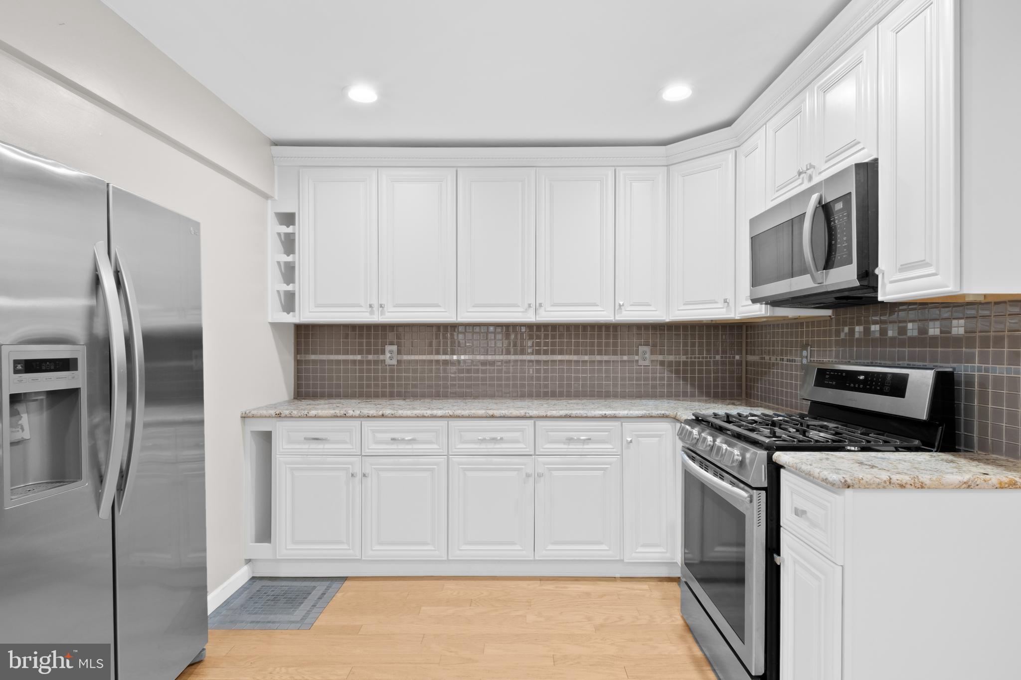 127 Heath Road Medford, NJ 08055 - Photo 17 of 63 a kitchen with stainless steel appliances granite countertop a stove a refrigerator and a microwave