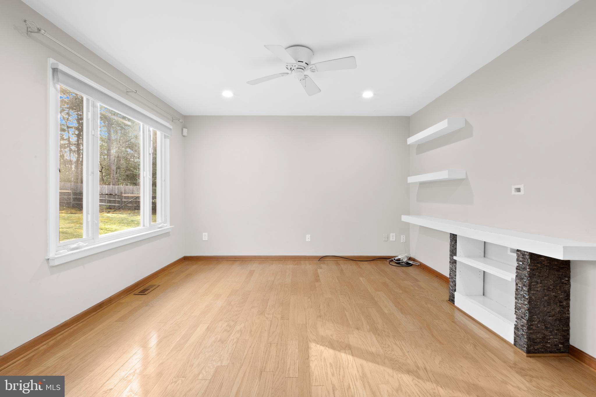 127 Heath Road Medford, NJ 08055 - Photo 21 of 63 a view of an empty room with a window and wooden floor