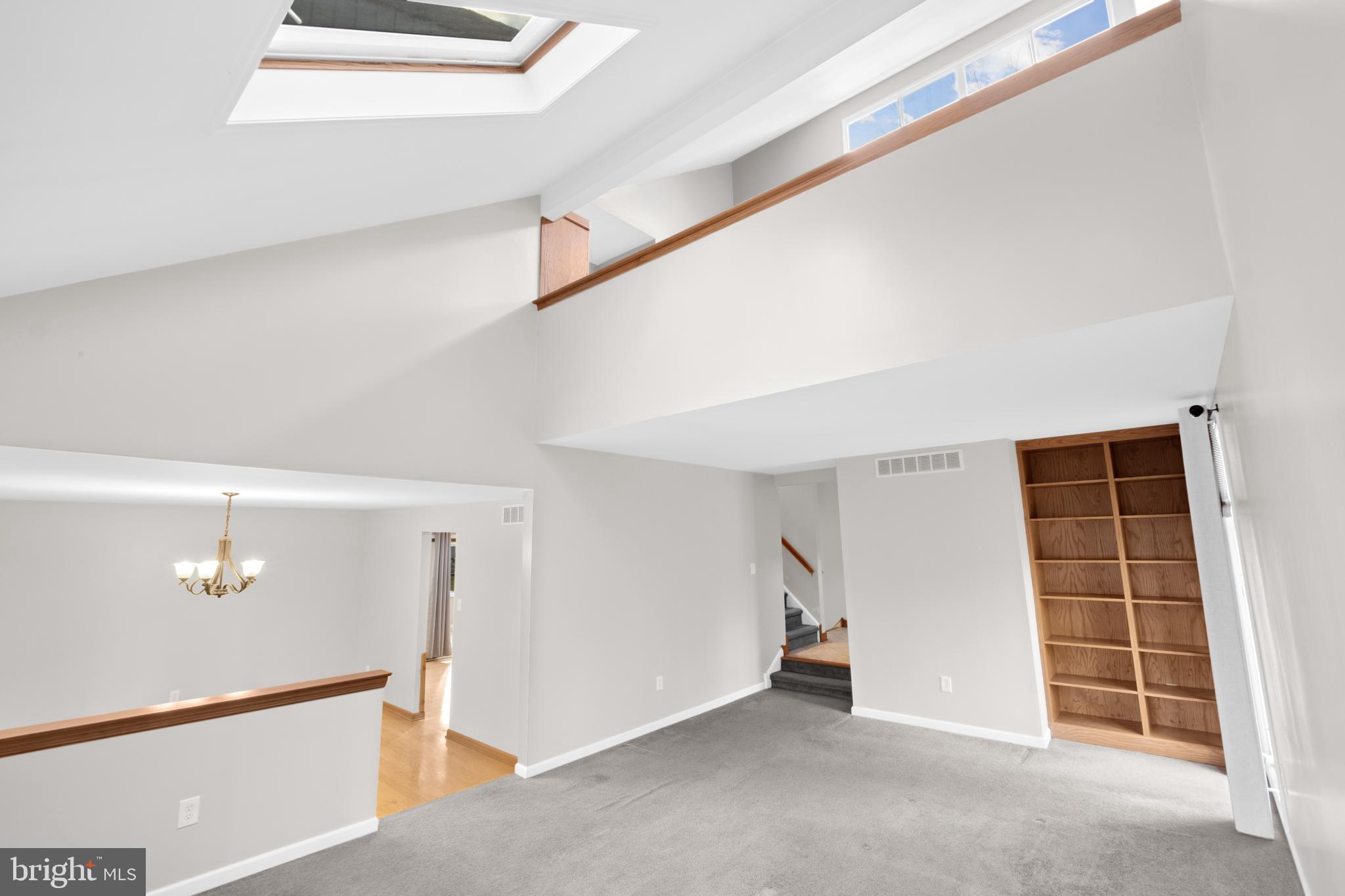 127 Heath Road Medford, NJ 08055 - Photo 10 of 63 a view of an empty room with stairs and white walls