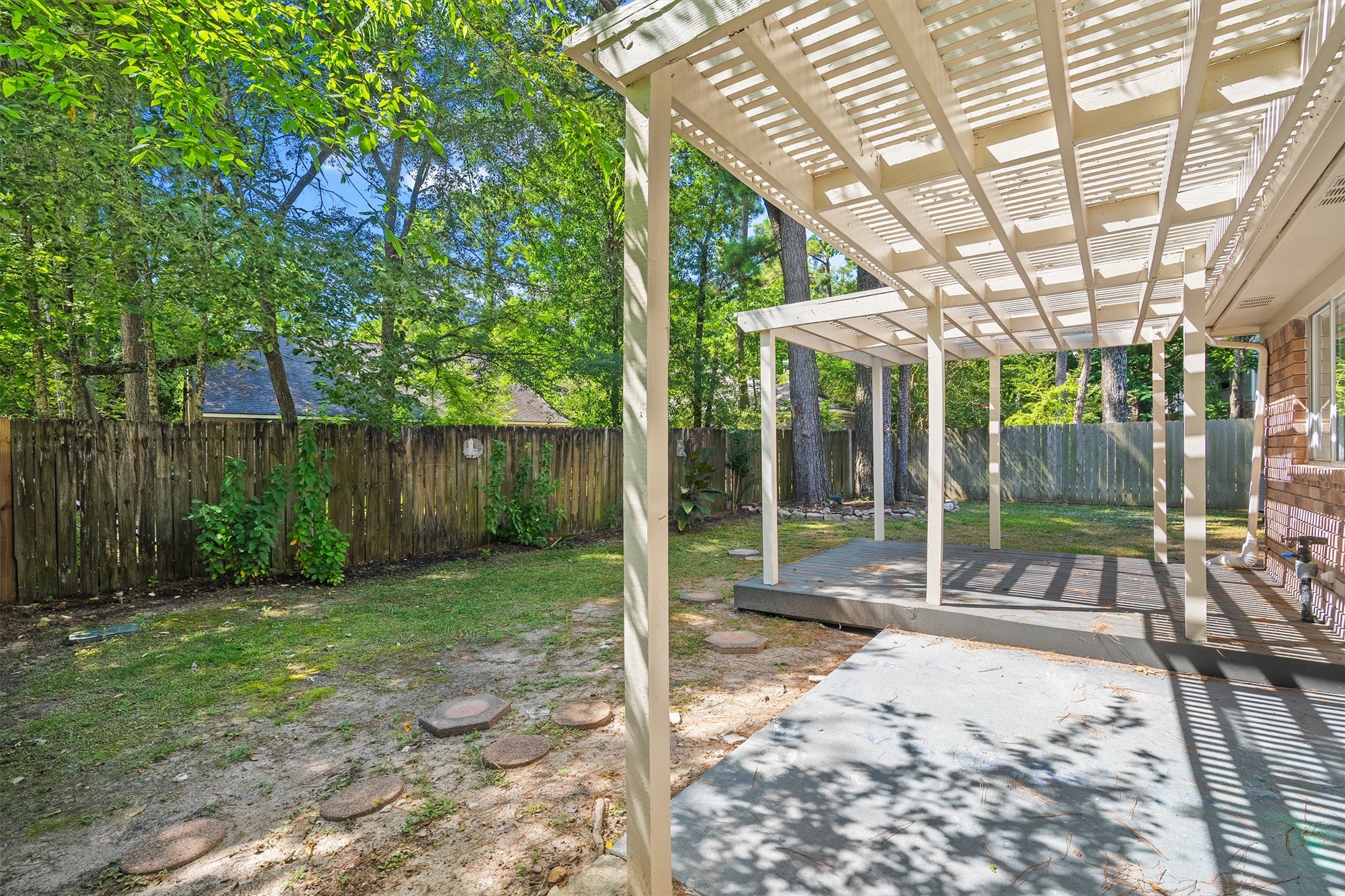 3 Still Corner Place Spring, TX 77381 - Photo 25 of 34 Just wait until you see the pergola-covered patio, the perfect setup for morning coffee or evening hangouts under that dappled shade! Add in some string lights and you've got a romantic escape at the end of a long day!