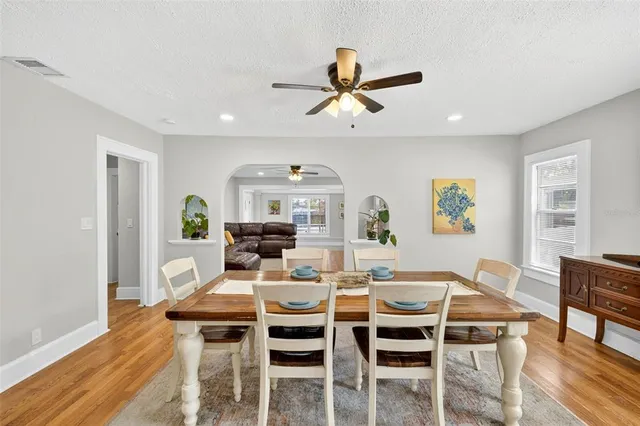 a dining room with furniture a window and wooden floor
