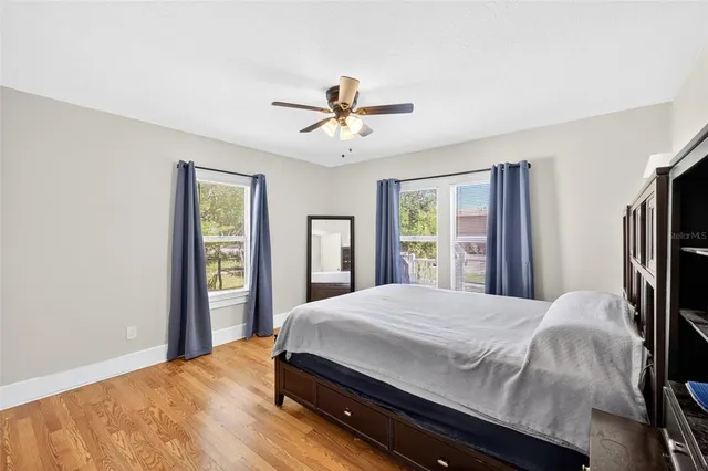 a bedroom with a large bed and a window