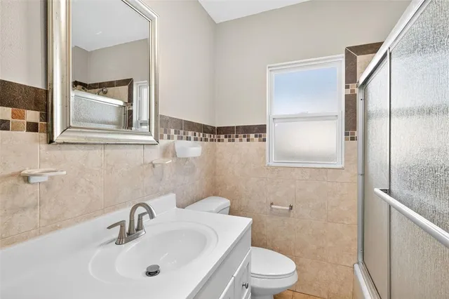 a bathroom with a toilet a sink and mirror