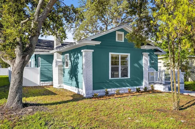a front view of a house with a yard balcony