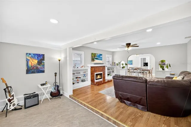 a living room with fireplace furniture and a flat screen tv