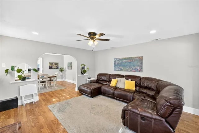a living room with furniture ceiling fan and a rug