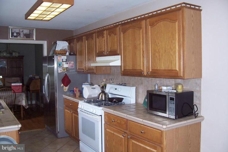 14011 Reva Road Boston, VA 22713 - Photo 5 of 18 a kitchen with stainless steel appliances granite countertop a sink stove and refrigerator