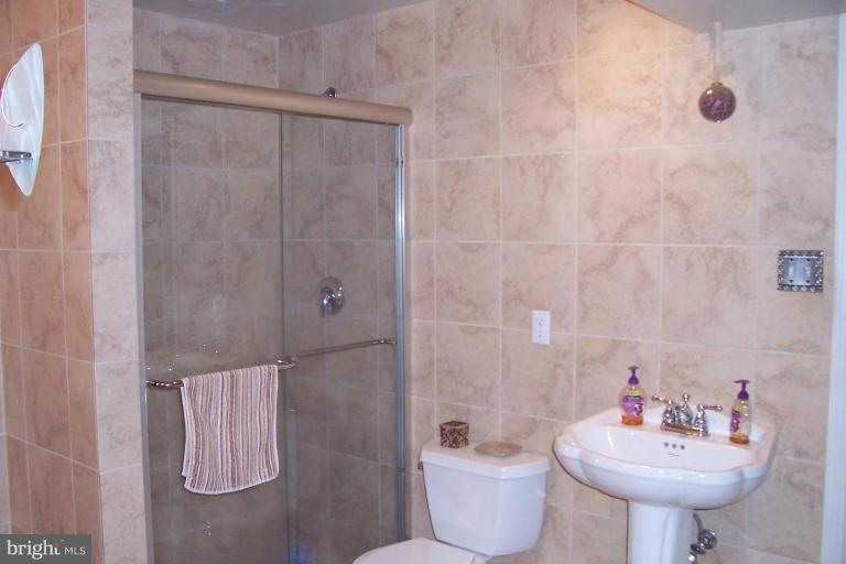 14011 Reva Road Boston, VA 22713 - Photo 9 of 18 a bathroom with a sink toilet and shower