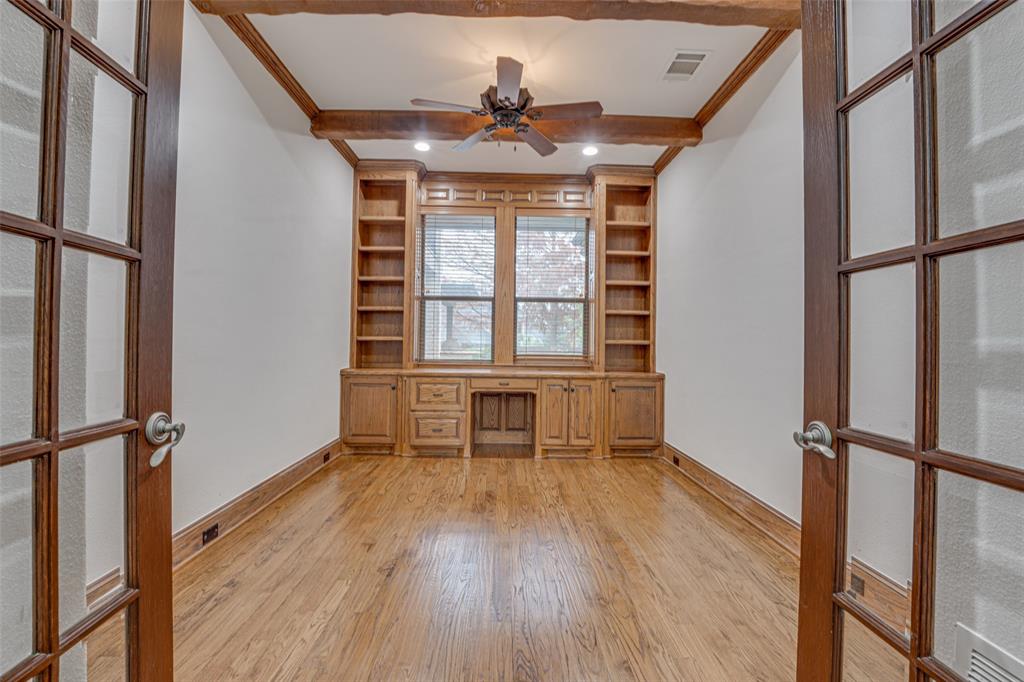 2216 Kings Pass Heath, TX 75032 - Photo 13 of 40 an empty room with wooden floor a ceiling fan and windows