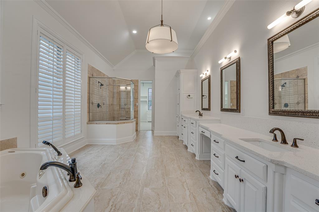 2216 Kings Pass Heath, TX 75032 - Photo 16 of 40 a bathroom with a double vanity sink a mirror and shower