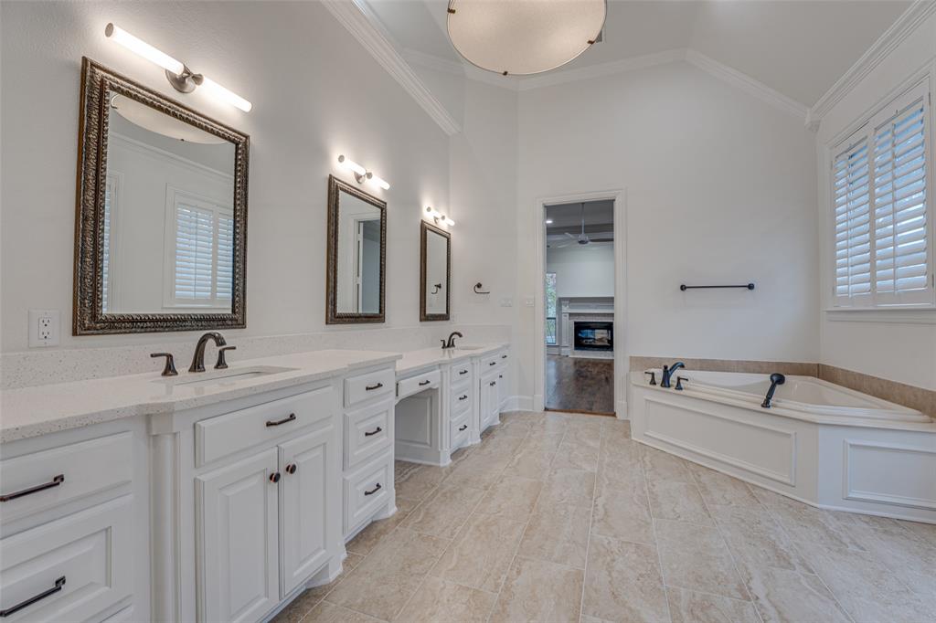 2216 Kings Pass Heath, TX 75032 - Photo 17 of 40 a spacious en suite bathroom with double sink and a large mirror