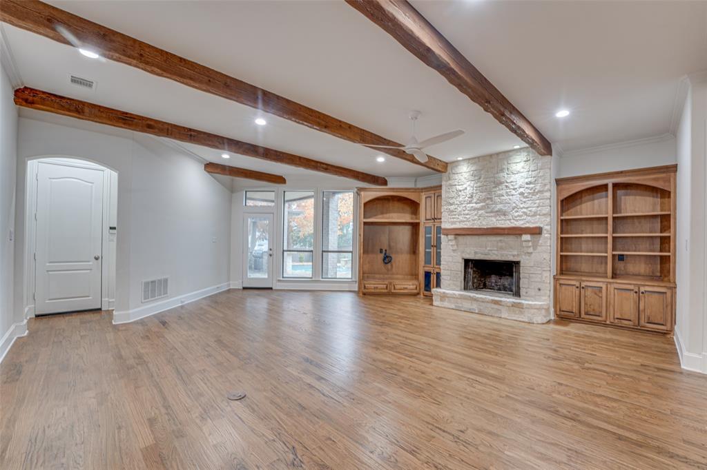 2216 Kings Pass Heath, TX 75032 - Photo 19 of 40 a view of empty room with wooden floor and fireplace